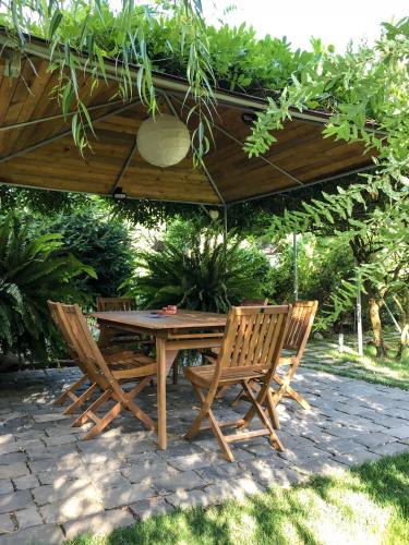 a wooden table and chairs under a wooden umbrella at Garden House in Timişoara