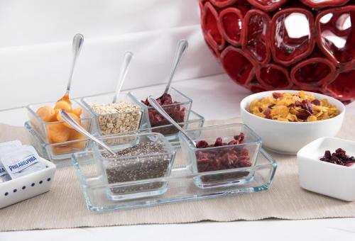 a group of containers of food and a bowl of fruit at Hotel Club Due Torri in Maiori