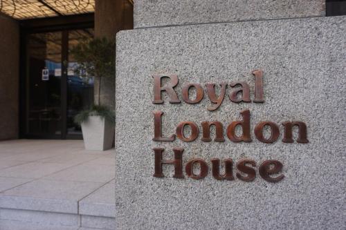 a sign for a royal london house in front of a building at Montcalm Royal London House, London City in London