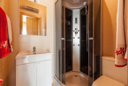 a bathroom with a shower and a toilet and a sink at Casa da Lagiela rural senses in Fafe