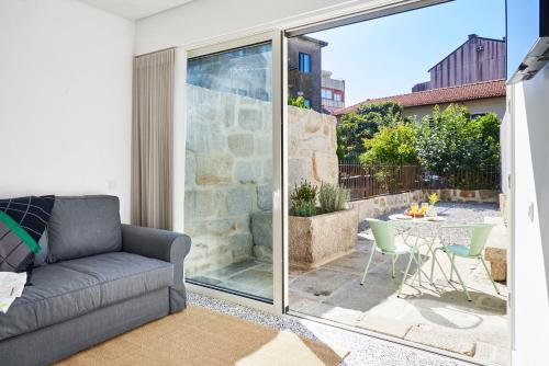 a living room with a couch and a table at Pause Apartments in Porto