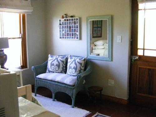 a living room with a chair and a mirror at Karoo Chat in Prince Albert