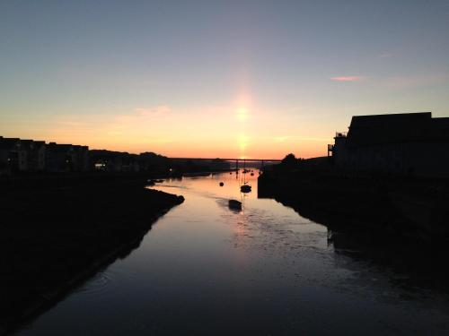 a river with boats in it at sunset at SPRING GARDENS B&B in Wadebridge