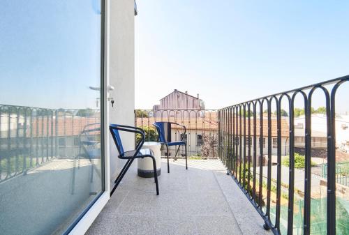 a balcony with chairs and a view of the city at Pause Apartments in Porto