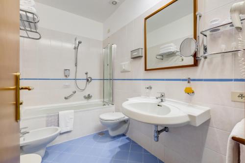 a bathroom with a sink and a toilet and a mirror at Best Western Hotel La Solara in Sorrento