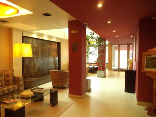 a living room with a couch and a table at MIL810 Ushuaia Hotel in Ushuaia