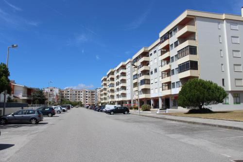 an empty street with cars parked in front of buildings at Ar Puro II in Viana do Castelo