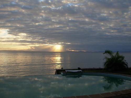 a swimming pool with a view of the ocean at Hotel Vanivola & SPA in Sainte Marie