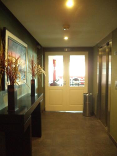 a hallway with a door and a room with plants at MIL810 Ushuaia Hotel in Ushuaia