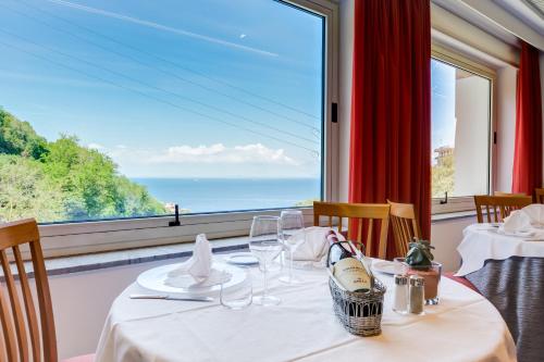 a dining room with a table and a large window at Best Western Hotel La Solara in Sorrento