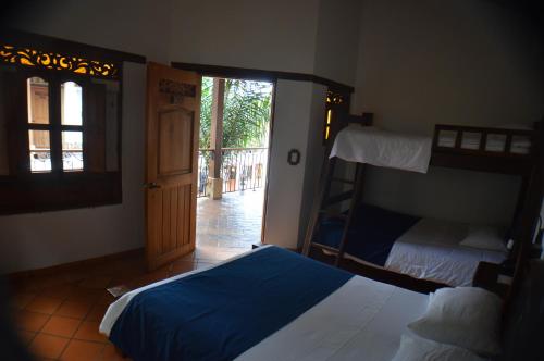 a bedroom with two bunk beds and a doorway at Hotel Boutique Villa Roma in Villa de Leyva