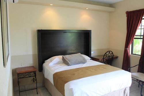 Ένα ή περισσότερα κρεβάτια σε δωμάτιο στο Hotel Hacienda del Viejo