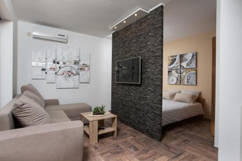 a living room with a couch and a table at Apartments Villa Diamant with Pool & Whirlpool in Čižići
