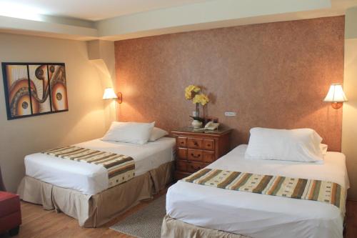 Ένα ή περισσότερα κρεβάτια σε δωμάτιο στο Hotel Hacienda del Viejo