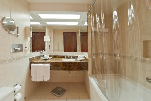 a bathroom with a shower and a sink at Radisson Hotel San Isidro in Lima