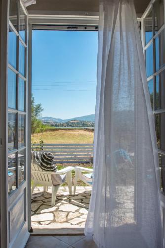 an open door to a patio with a table and a bench at Ailanto in Lygia