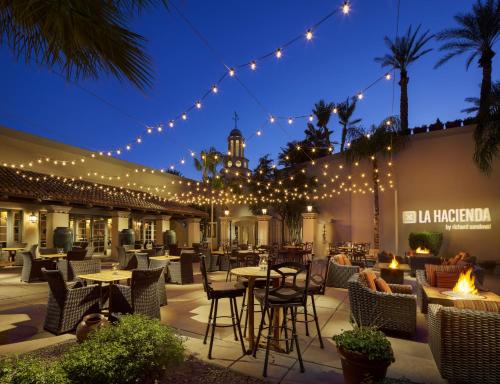 a patio with tables and chairs and lights at Fairmont Scottsdale Princess in Scottsdale