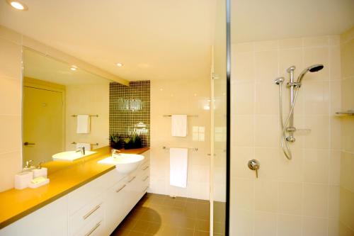 a bathroom with a sink and a shower at Loka Santi Penthouse 14 OCEAN VIEWS in Agnes Water