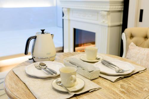 a table with plates and cups and a coffee maker at Guest Villa Hakone Yumoto 101 in Hakone