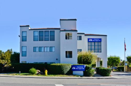 a white building with a fire hydrant in front of it at America's Best Value Inn of Novato in Novato