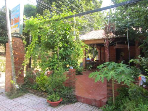 a garden in front of a house with plants at Gia Thanh Phu Quoc Guest House in Phu Quoc