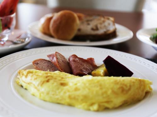 a plate of breakfast food on a table at Dancewoods Hotel in Wujie