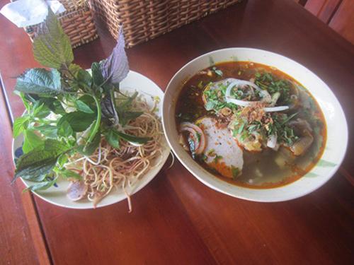 a bowl of noodles and a bowl of soup on a table at Gia Thanh Phu Quoc Guest House in Phu Quoc