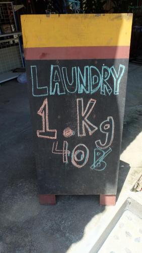 a sign that says laundry taped to a box at Captan Home in Haad Chao Phao