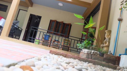 a pile of rocks in front of a house at Captan Home in Haad Chao Phao