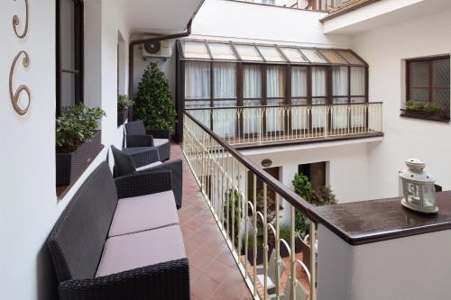 an apartment balcony with black chairs and a railing at Old Prague House in Prague