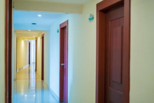 an empty hallway with two doors and a hallway at Green Park Residency in Kannur