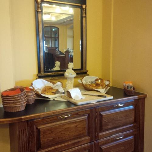 a wooden dresser with a mirror on top of it at Berg-Gasthof Honigbrunnen in Löbau