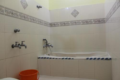 a bath tub in a bathroom with a toilet at Hotel Sea View Palace - the beach hotel in Kovalam