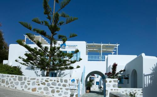 a tree in front of a white building at Folegandros Apartments in Chora Folegandros
