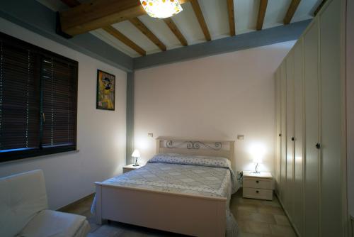 a bedroom with a bed and two lamps in it at Il Vecchio Scornabecco in Scapezzano