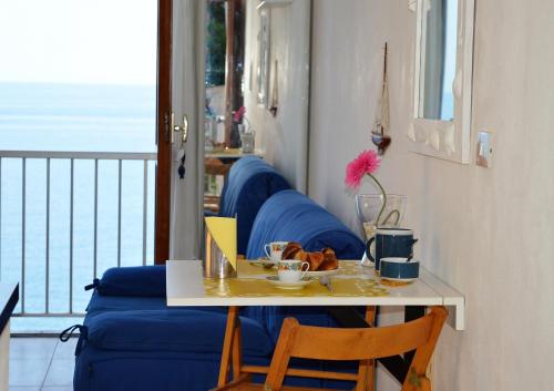 a table with a plate of food and a laptop at House Grecale in Moneglia