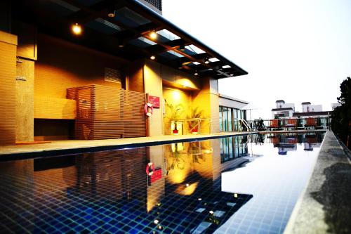 a swimming pool in front of a building at Maison de Chine Taichung (Pin Chen) in Taichung