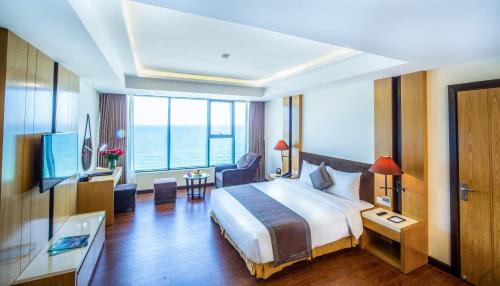 a hotel room with a large bed and a large window at Muong Thanh Luxury Da Nang Hotel in Da Nang