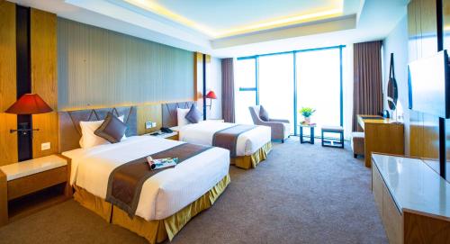 a hotel room with two beds and a television at Muong Thanh Luxury Da Nang Hotel in Da Nang