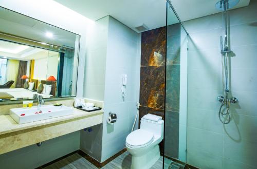a bathroom with a toilet and a sink and a shower at Muong Thanh Luxury Da Nang Hotel in Da Nang