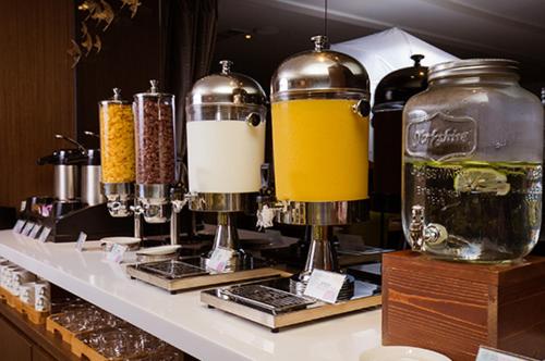 a counter with some bottles of alcohol and some glasses at Aeris International Hotel in Taichung