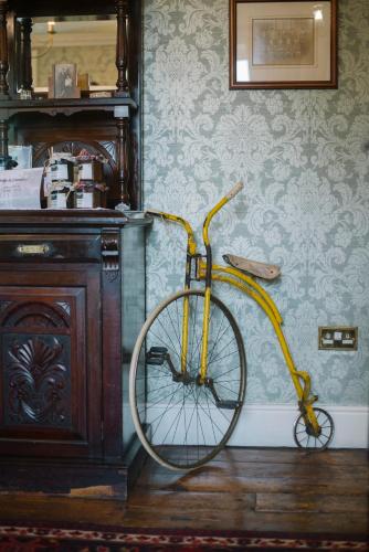 a yellow bike parked against a wall in a room at Ghan House in Carlingford