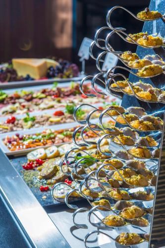 a buffet line with many different types of food at Castellum Hotel Hollókő in Hollókő
