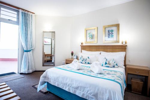 a bedroom with a large bed and a large window at First Group La Cote D'Azur in Margate