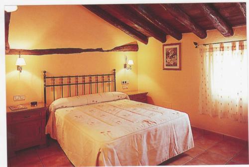 a bedroom with a large bed and a window at Parada del Carmen in Albarracín