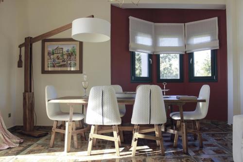 a dining room with a table and chairs at Pleiades Luxury Villa in Svoronata