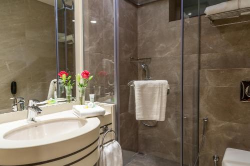 a bathroom with a sink and a shower at Gerasa Hotel in Amman