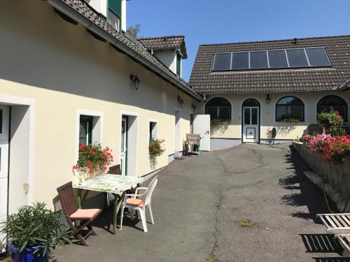 a courtyard of a house with a table and chairs at Gästehaus Lindenhof in Jennersdorf