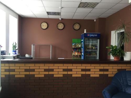 a bar in a restaurant with clocks on the wall at Karavella in Mykolaiv