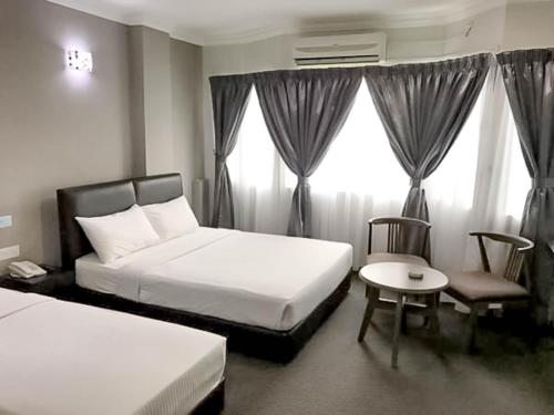 Кровать или кровати в номере Myangkasa Akademi & Resort Langkawi
